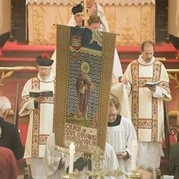 The St. Barnabas banner joins the procession at the opening of the Feast of Dedication service