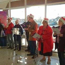 Four Oaks singing Carols at Sainsbury's in Mere Green