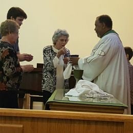 Pastor Donnie offers communion to  Rev. Nancy,  David, and Nancy